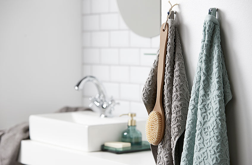 Mønstrede håndklær som henger på et bad