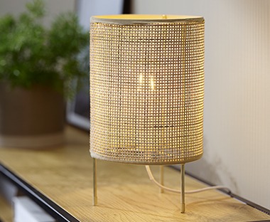Moderne bordlampe i rattan som skaper en spennende lyseffekt i rommet