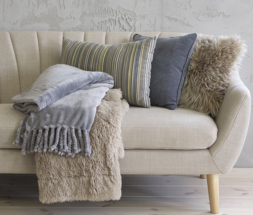 EGEDAL sofa med BONDEROSE fleeceteppe i blått, MYRFIOL pledd i fuskepels, KORALLROT stripete pute, HORNFIOL blå pute og TAKS pute med fuskepels Sofa med fleecepledd, stripete og blå puter og pute i fuskepels