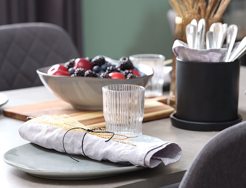 Table set with bowls, glasses and plates with cloth napkins