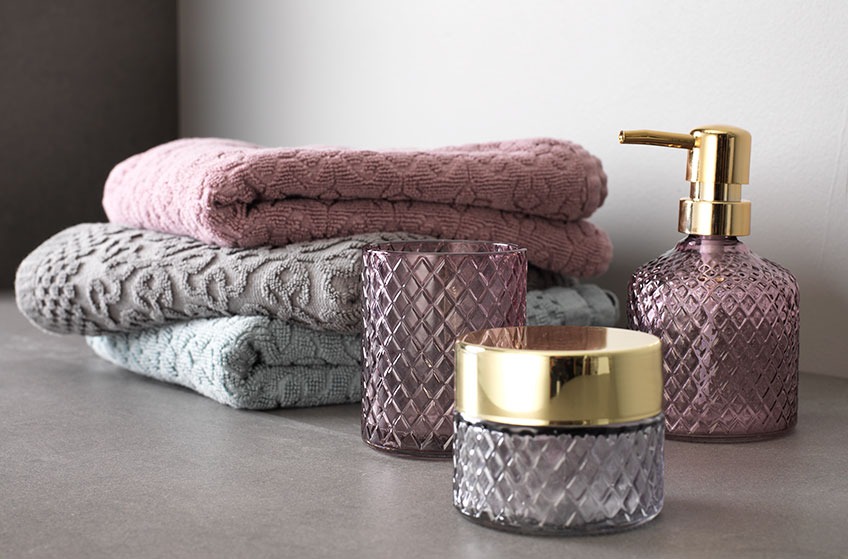 bathroom accessories and towels in different colours